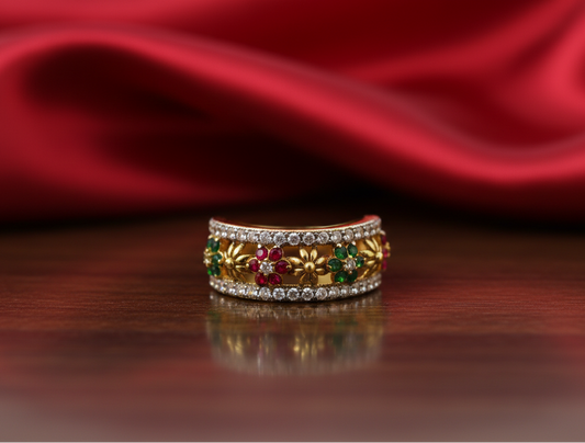 Decorative ring with gemstones on a reflective surface with red fabric in the background